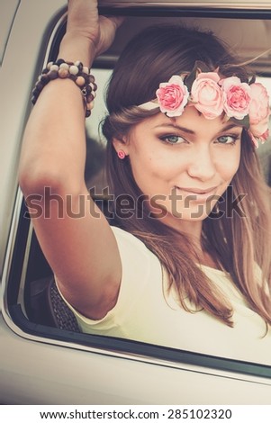 Hippie girl in a van on a road trip