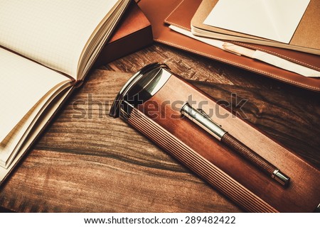 Luxurious writing tools on a wooden table
