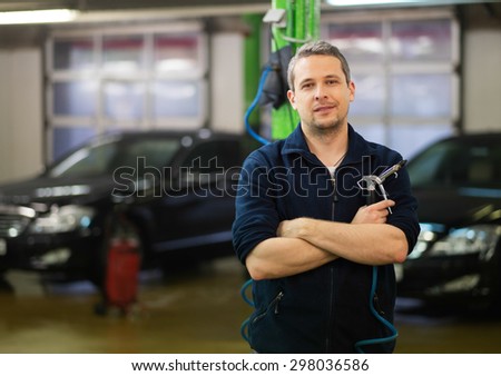 Happy worker on a car wash