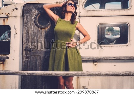Stylish woman on old rusty boat