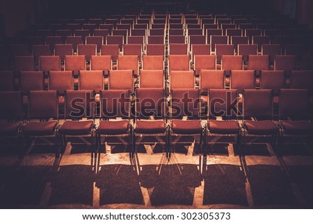 Empty comfortable red seats in a hall