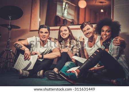 Multiracial music band in a recording studio