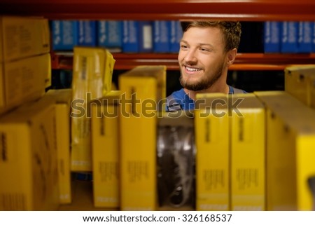 Worker on a automotive spare parts warehouse
