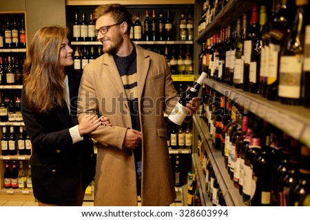 Couple choosing alcohol in a liquor store