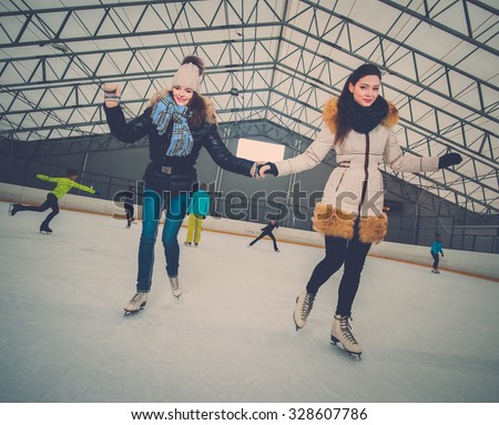 Two girls on ice-skating rink