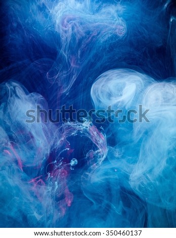 Smoky blue and pink ink in motion on water isolated on black