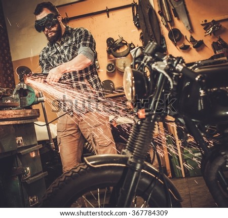 Mechanic doing lathe works in motorcycle customs garage
