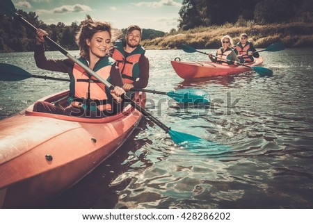 Happy best friends having fun on a kayaks