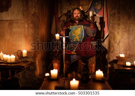 Old medieval king on the throne in ancient castle interior.