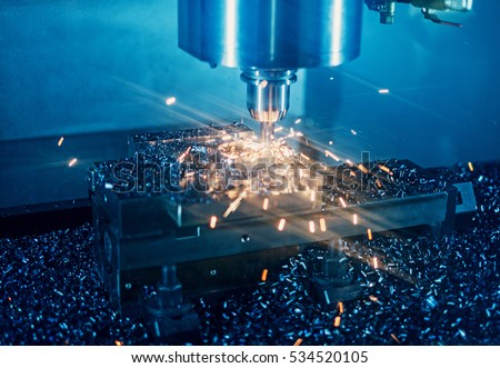 Milling machine working on steel detail with lot of sparks