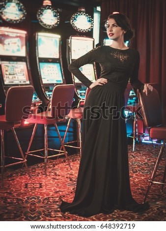 Beautiful woman near slots machines in a luxury casino interior
