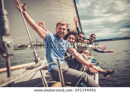 Happy friends resting on a yacht