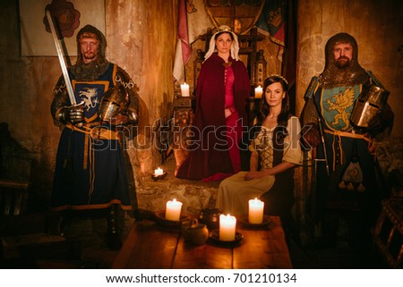 Medieval queen with her knights on guard