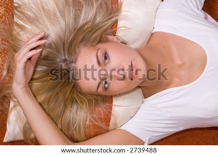 Girl with natural blond hair lying on the floor
