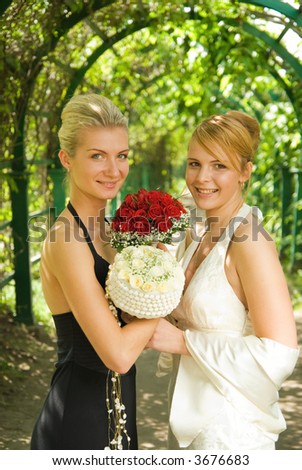 Two girls with a flowers in green alley
