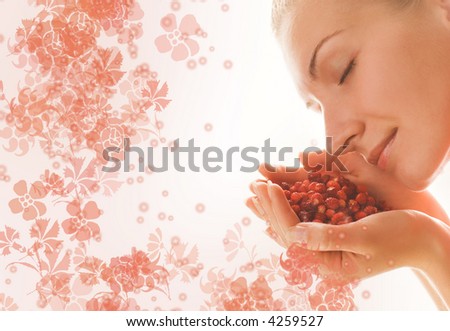 Beautiful girl with a handful of aromatic berries