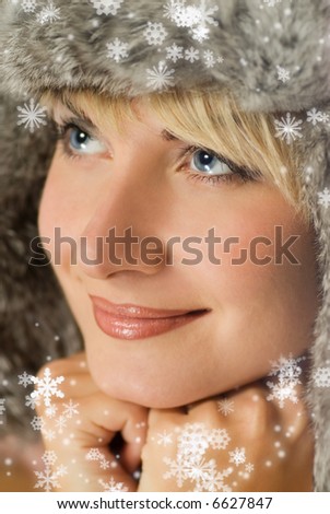 Beautiful girl in winter fur-cap