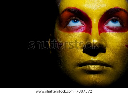Portrait of a mysterious woman with artistic make-up on her face. Isolated on black background