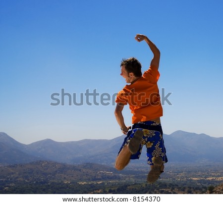 Happy guy jumping in mountains