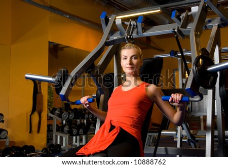 Beautiful woman works out in a gym