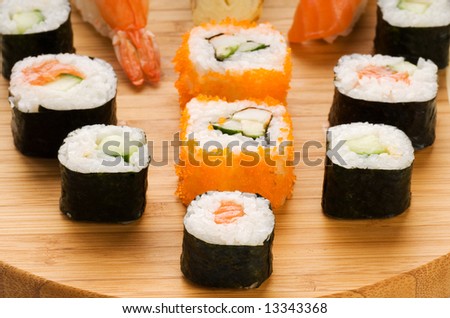 Different types of sushi on a bamboo plate