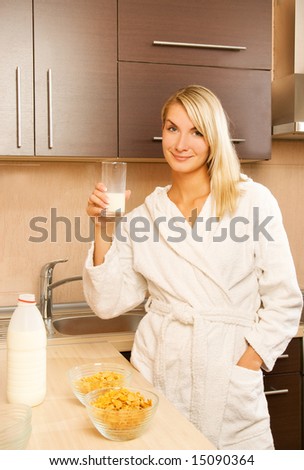Beautiful young woman drinking milk in the morning