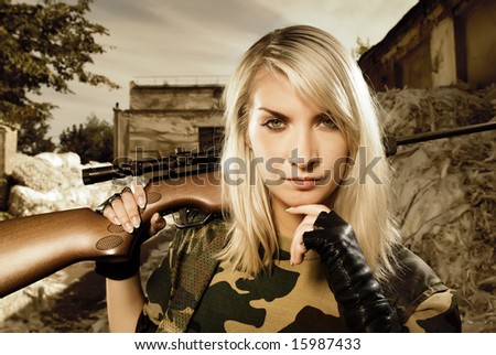 Beautiful woman soldier with a sniper rifle