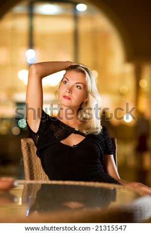 Beautiful young woman in a restaurant at evening