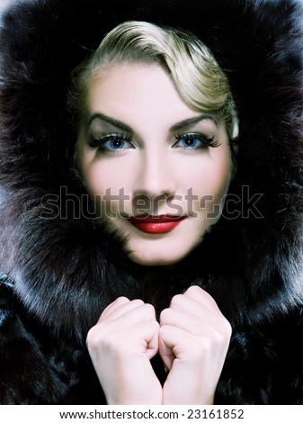 Beautiful woman in winter fur coat. Toned in blue