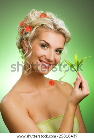 Beautiful blond woman with young plant.