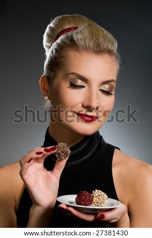 Charming lady tasting chocolate