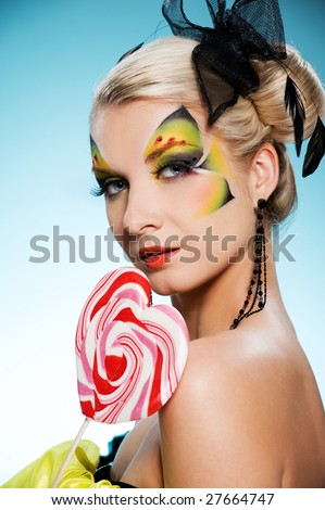stock photo Young beauty with butterfly faceart heart shaped lollipop