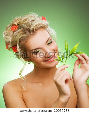 Young woman with green plant. Isolated on white