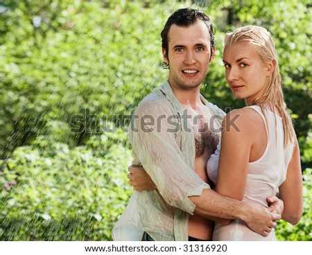 young couple kissing in the rain. young couple kissing in the