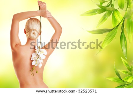 Beautiful blond woman with orchid flower