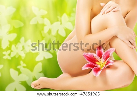 Beautiful woman body with pink lily flower. Spring concept