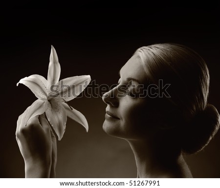 Monochrome picture of a beautiful woman with lily flower