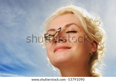 Beautiful butterfly sitting on a woman nose