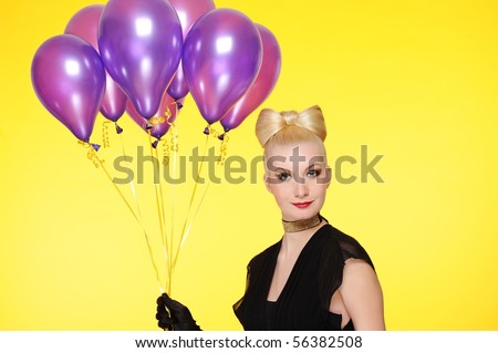 Beautiful lady with a bunch of purple balloons