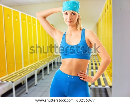 Beautiful sporty woman in locker room