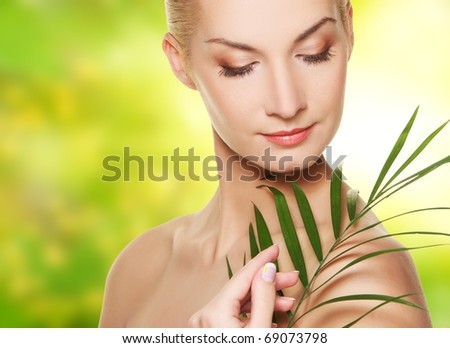 Close-up of a woman face with green plant