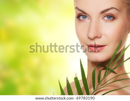 Close-up of a woman face with green plant