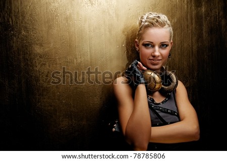 Attractive steam punk girl with headphones smiling