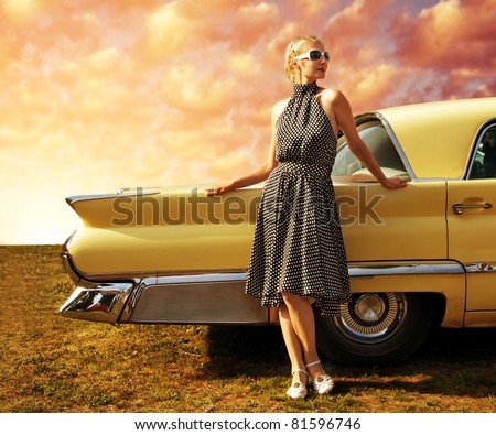 Beautiful lady standing near retro car.