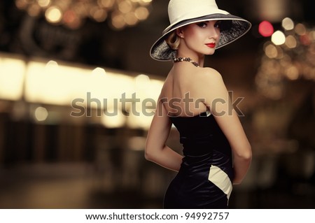 Woman in hat over blurred background.