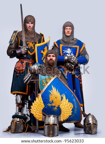 Three medieval knights isolated on grey background.