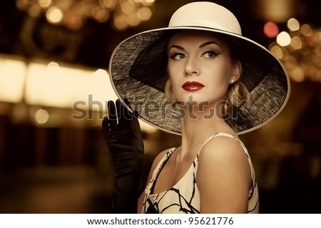 Woman in hat over blurred background.