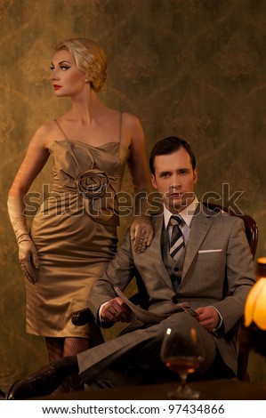Retro couple sitting behind table.