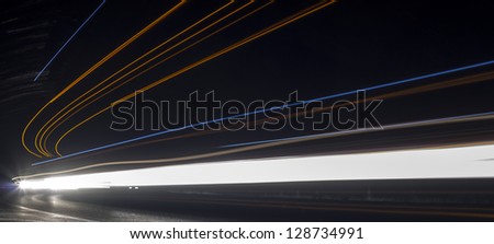 Truck light trails in tunnel. Art image . Long exposure photo taken in a tunnel
