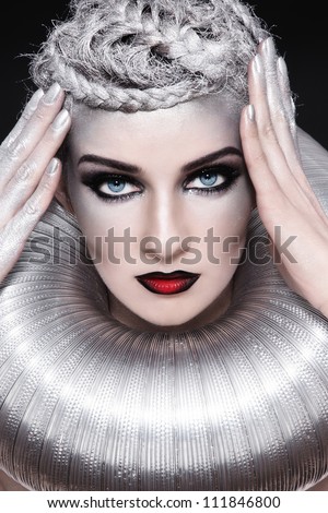 Portrait of young beautiful woman with stylish fancy make-up and silver hair